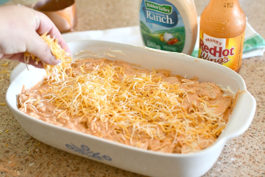 adding cheese to buffalo chicken dip