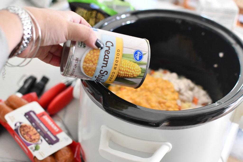 Adding a can of creamed corn to sausage corn chowder. 