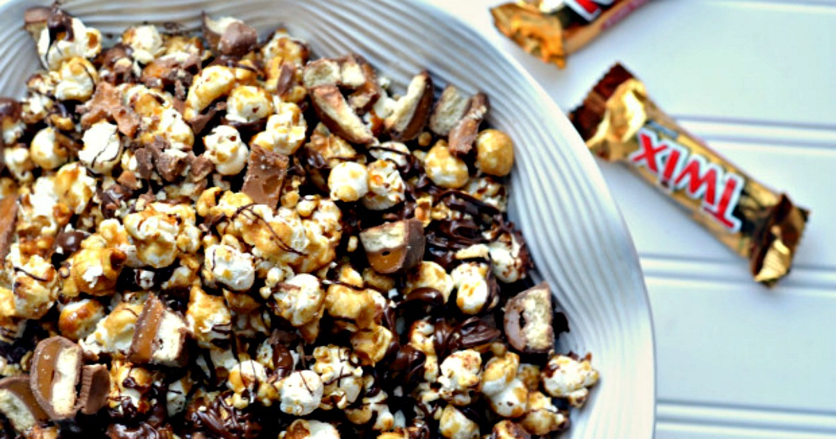 twix caramel popcorn recipe – in a serving bowl next to Twin candy bars