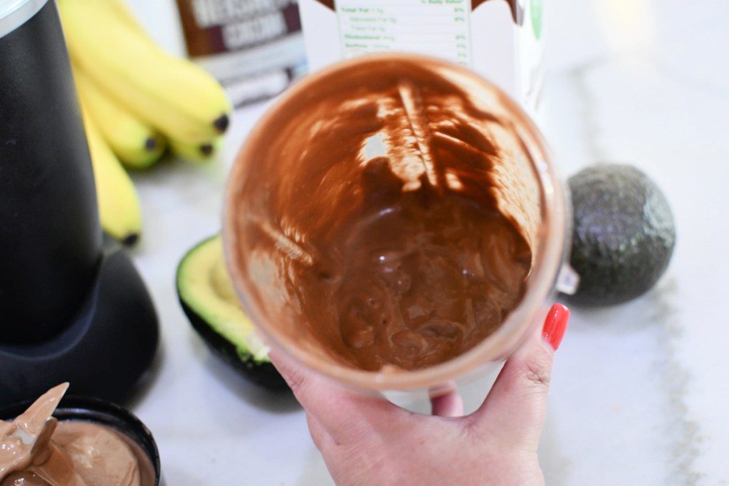 blender with avocado smoothie inside