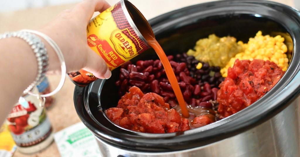 adding red enchilada sauce to taco soup