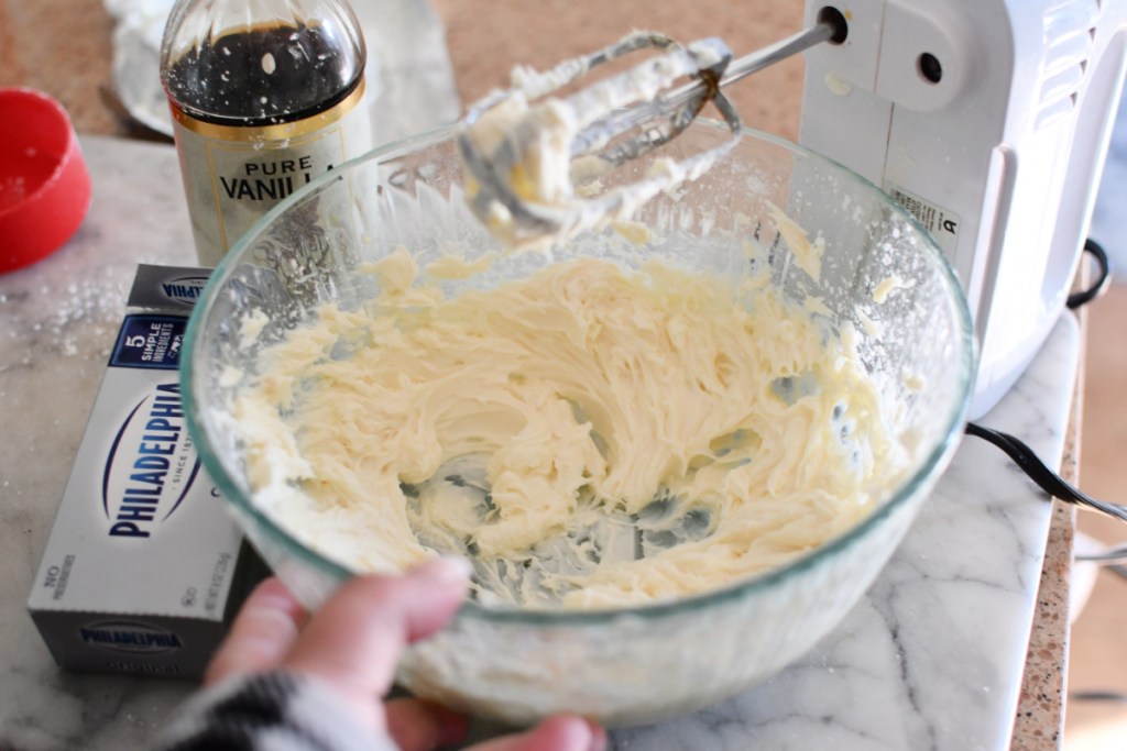 mixing cream cheese and sugar in a bowl 