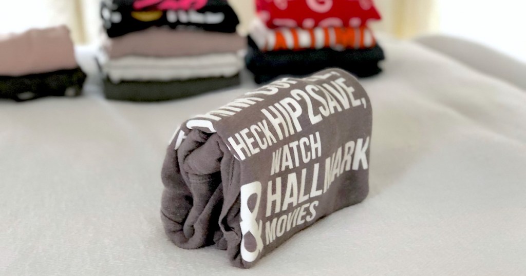 folded sweatshirt with words and laundry in the background