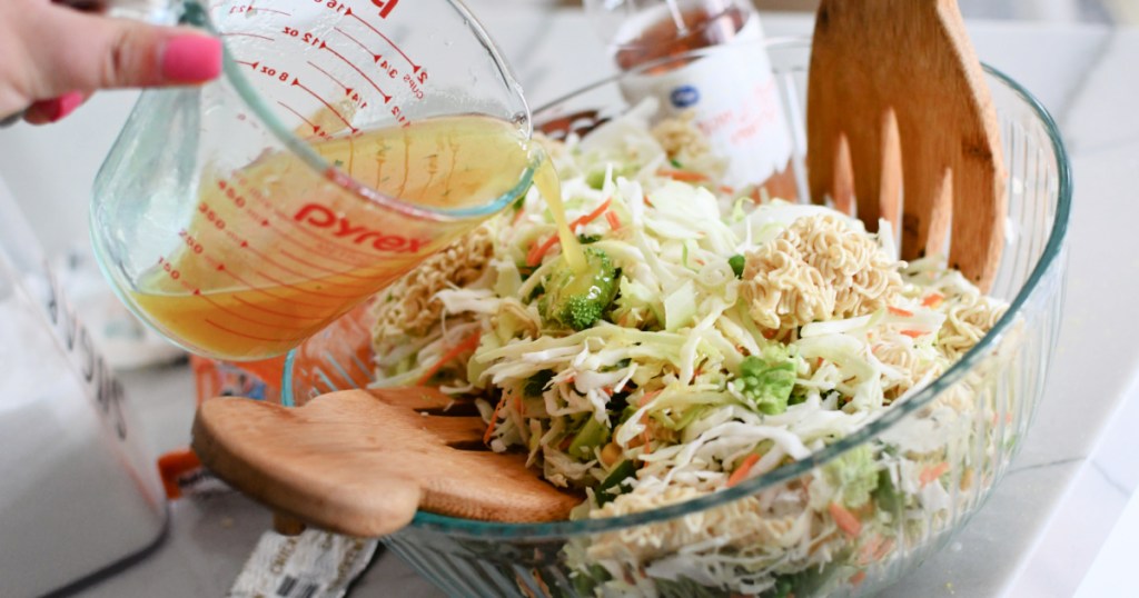 pouring dressing on ramen noodle salad