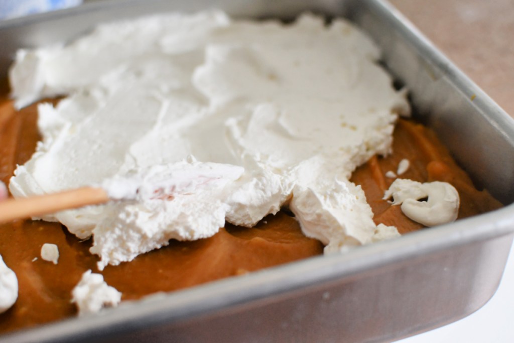 adding whipped topping to dessert