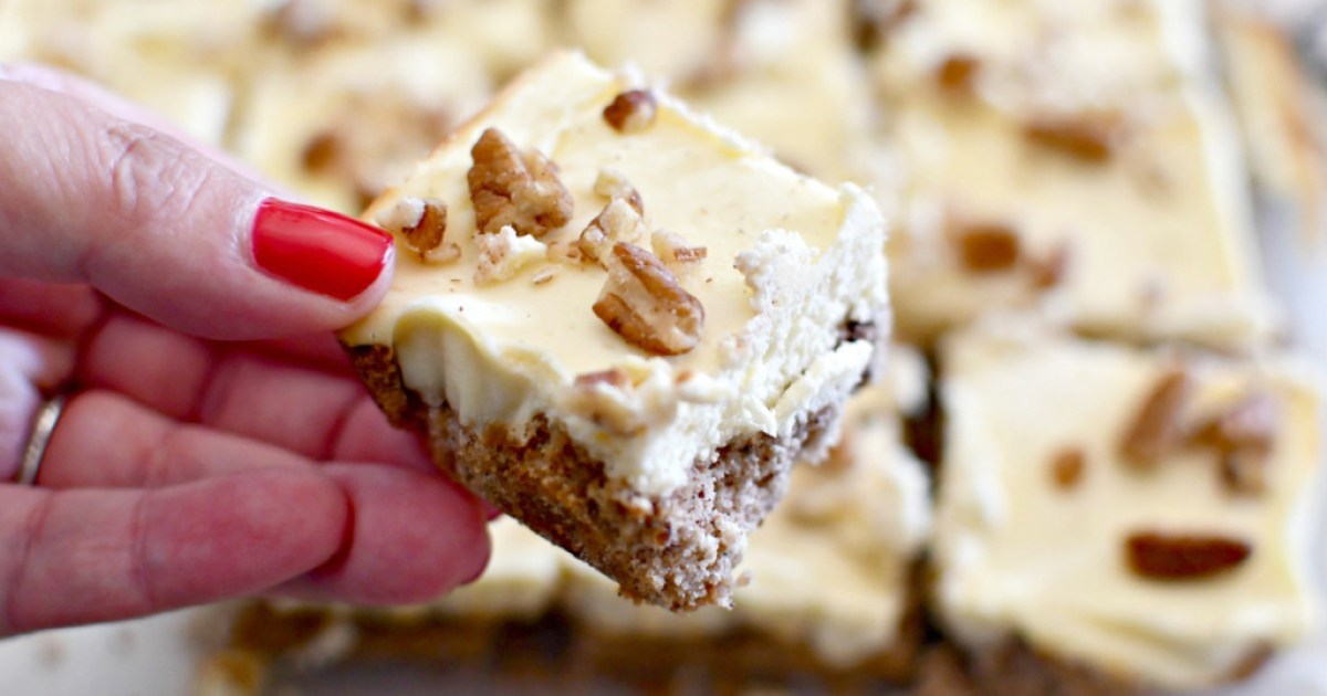 hand holding a cream cheese pecan bar
