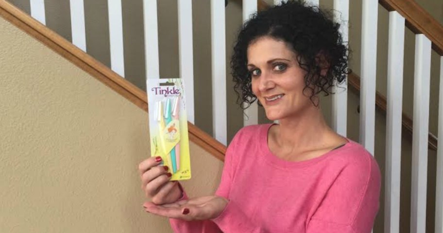 woman holding tinkle dermaplane