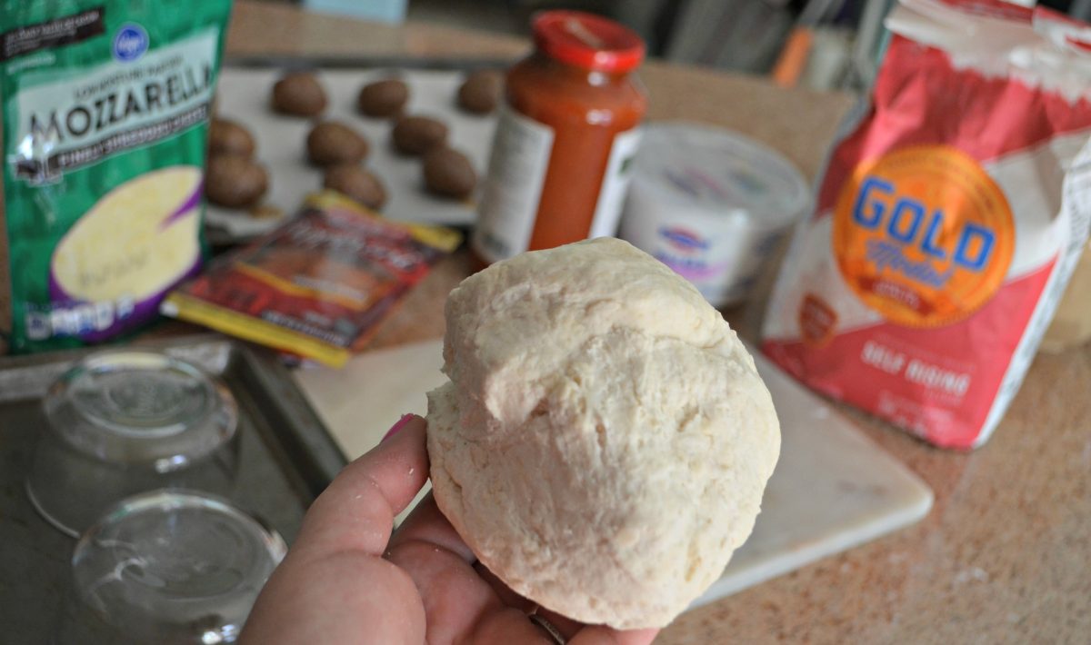 holding a ball of dough