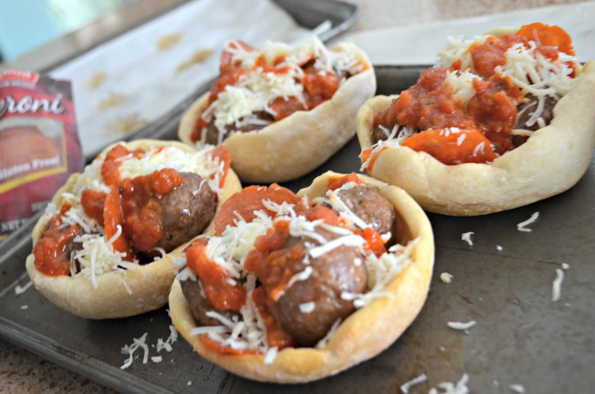 copycat Olive Garden meatball pizza bowls on a baking sheet, ready to go into the oven 