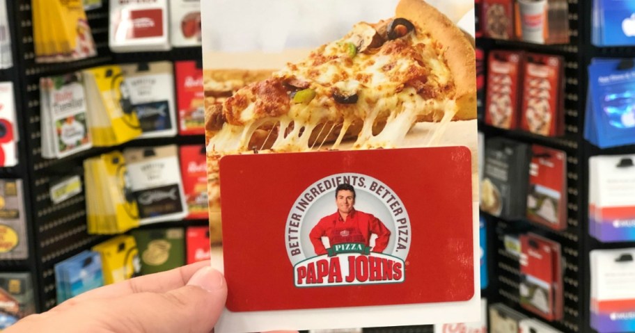 Hand holding a Papa John's gift card