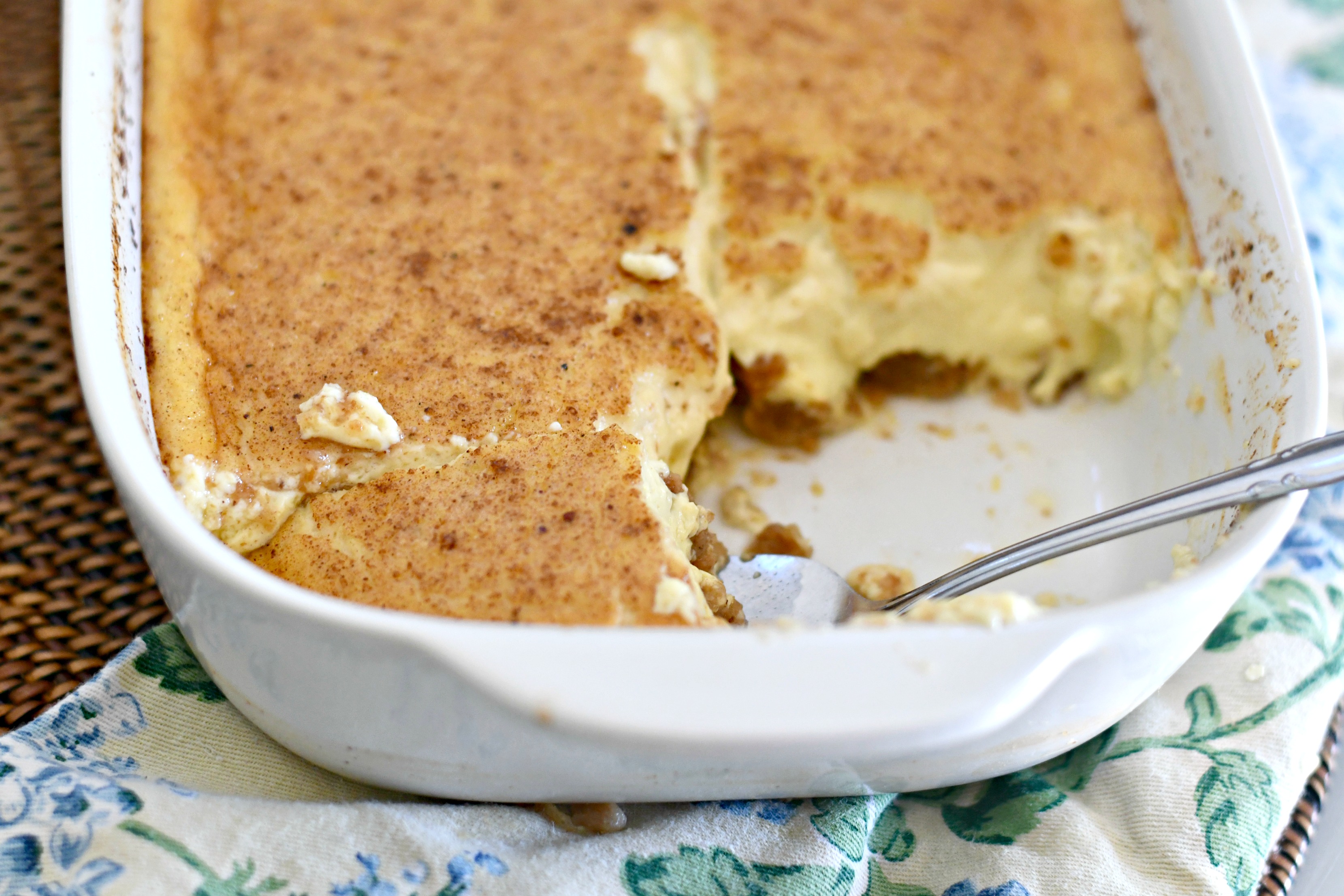 Classic Grape-Nuts Pudding closeup with a serving gone to show the pudding inside