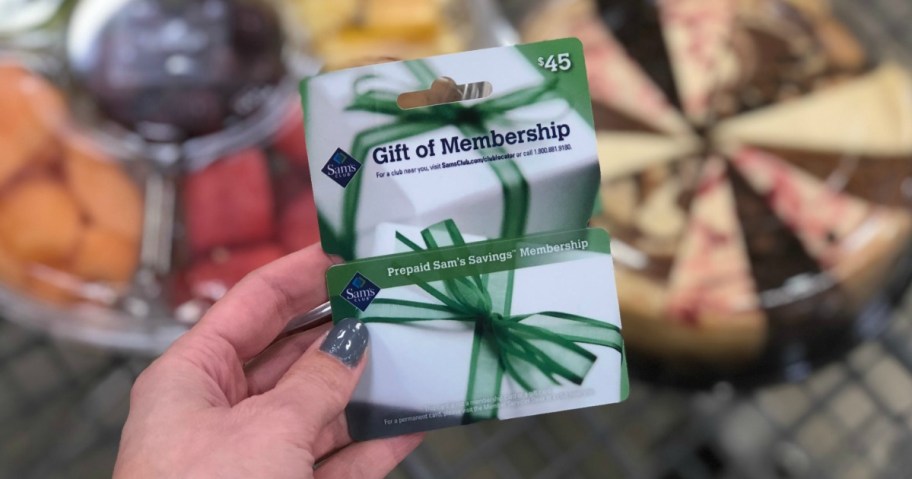 Hand holding up a sams club membership card