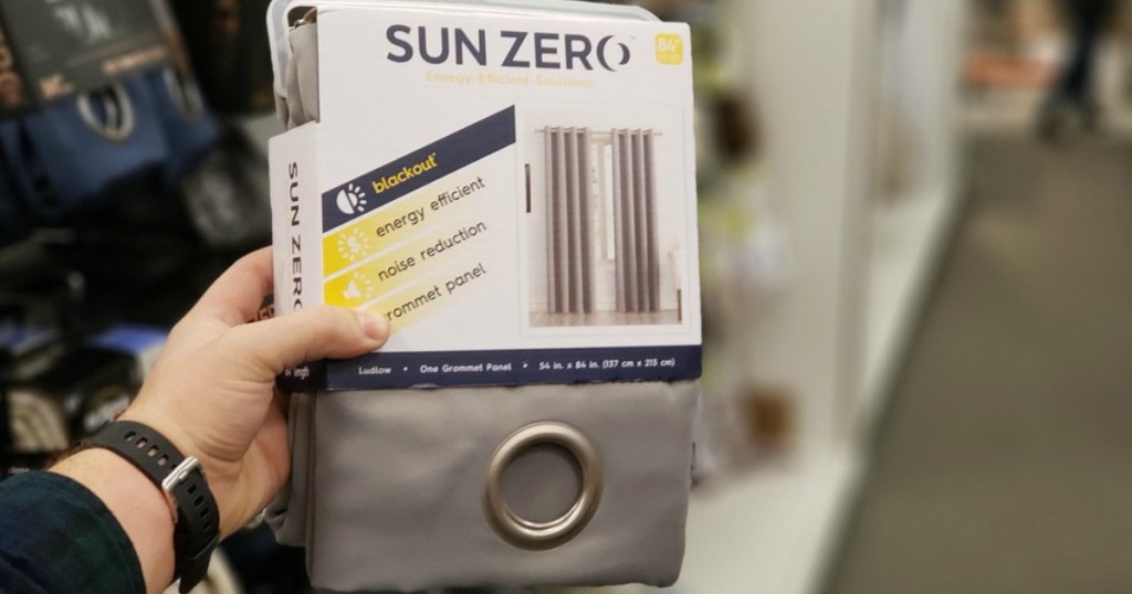 hand holding a pair of curtains in store