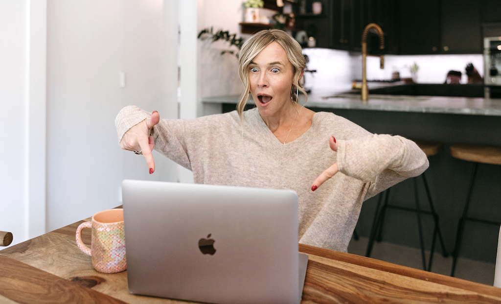 http://woman%20pointing%20to%20MacBook
