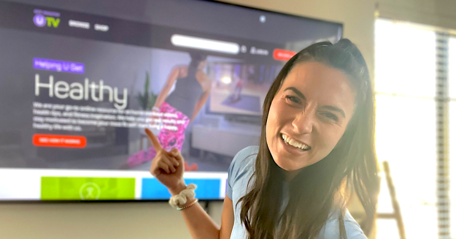 girl pointing to tv with healthy u on it 