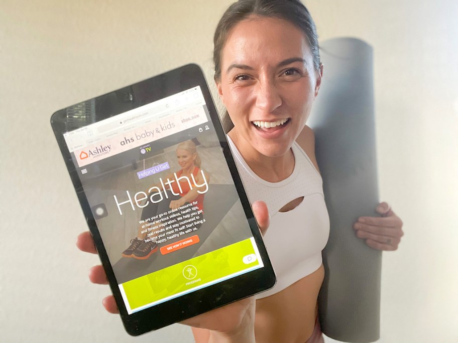 woman holding ipad with healthy u on it 