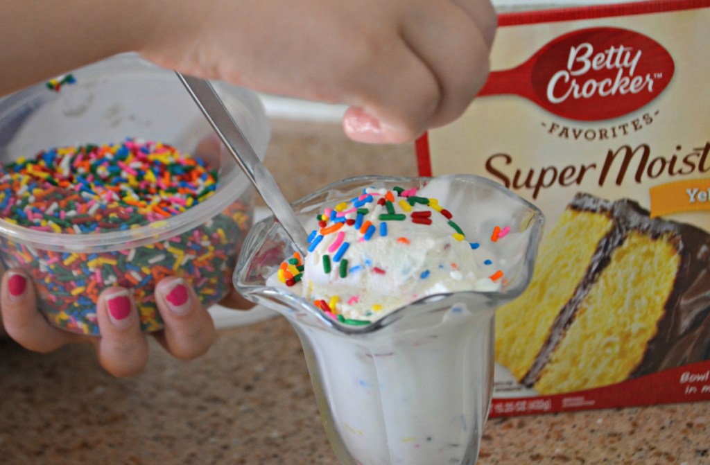 Placing sprinkles on cake batter ice cream