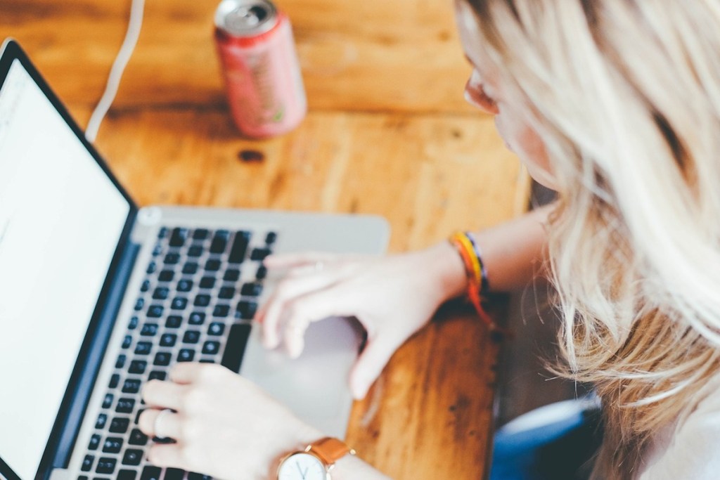 girl typing on computer laptop
