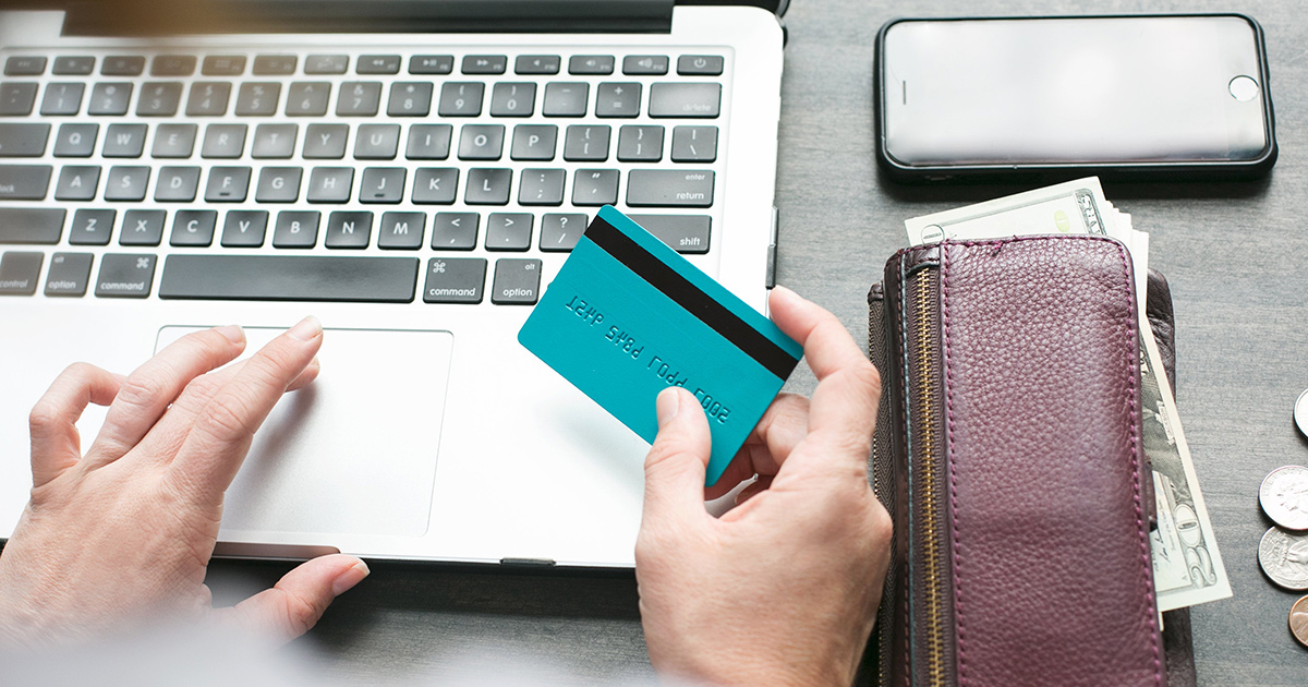 person at computer with credit card