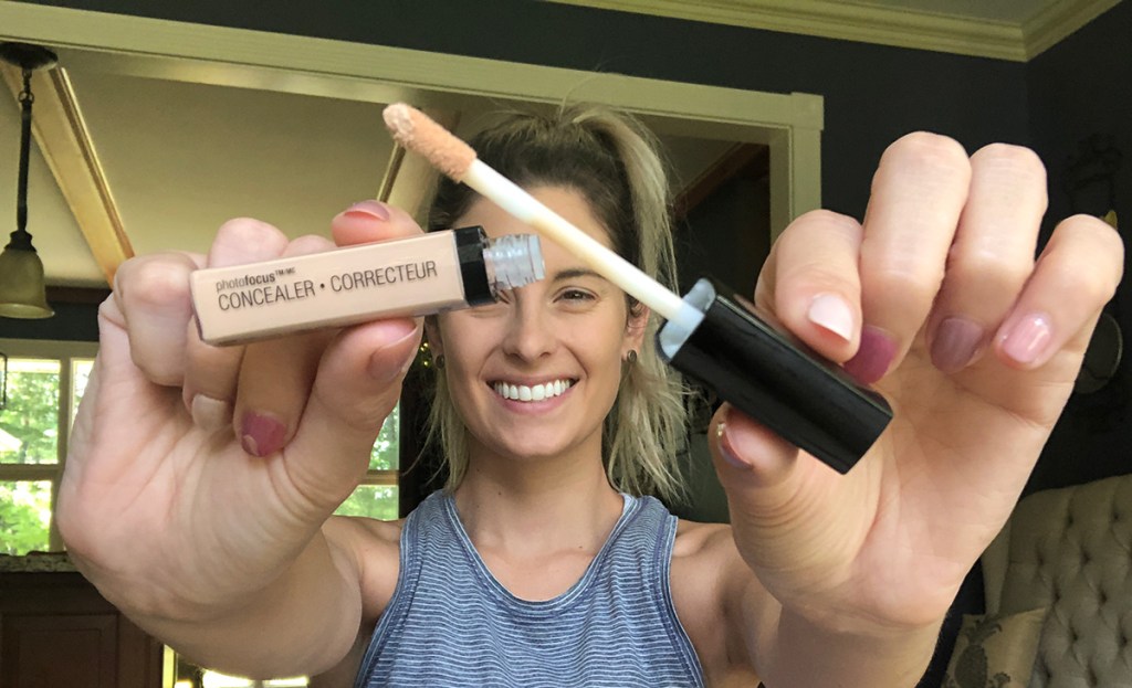 emily holding up wet n wild concealer