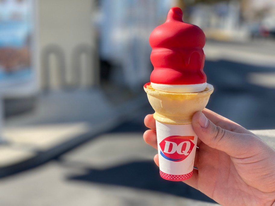 hand holding DQ cherry dipped cone