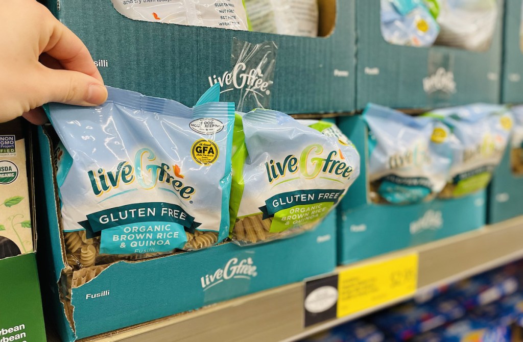 hand pulling bag of pasta out of box