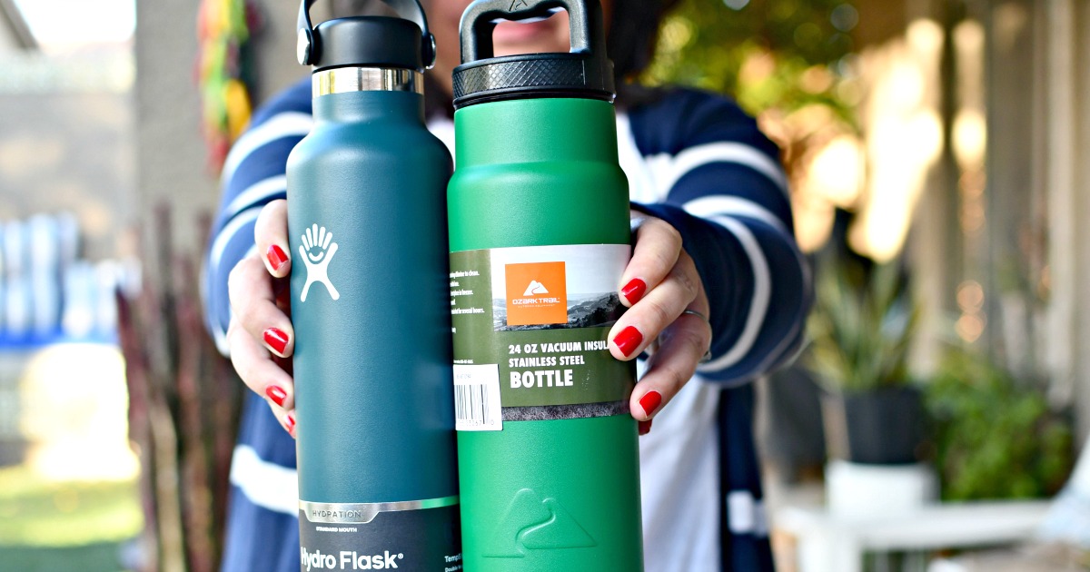 holding 2 insulated water bottles 