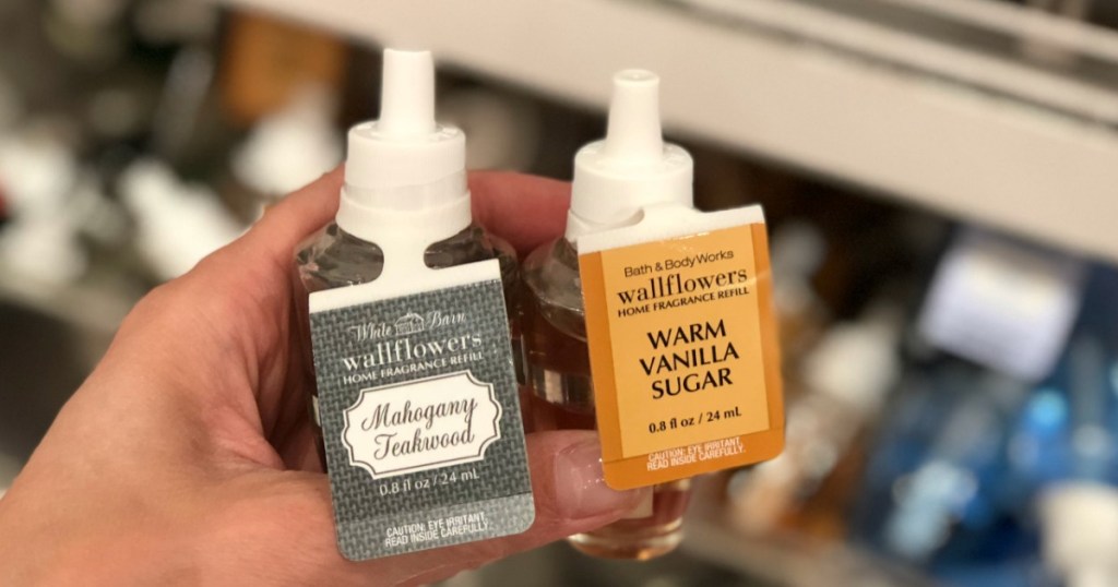 hand holding two Bath & Body Works wallflower refills