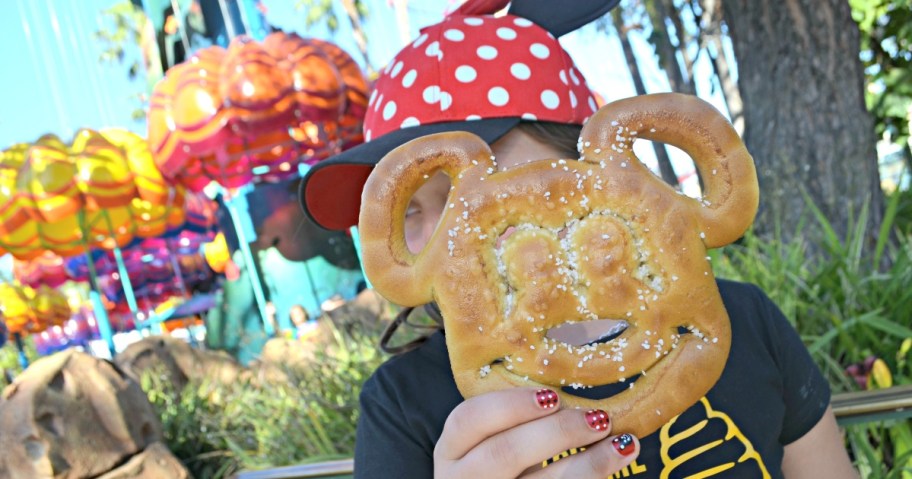 girl holding Mickey pretzel at Disneyland