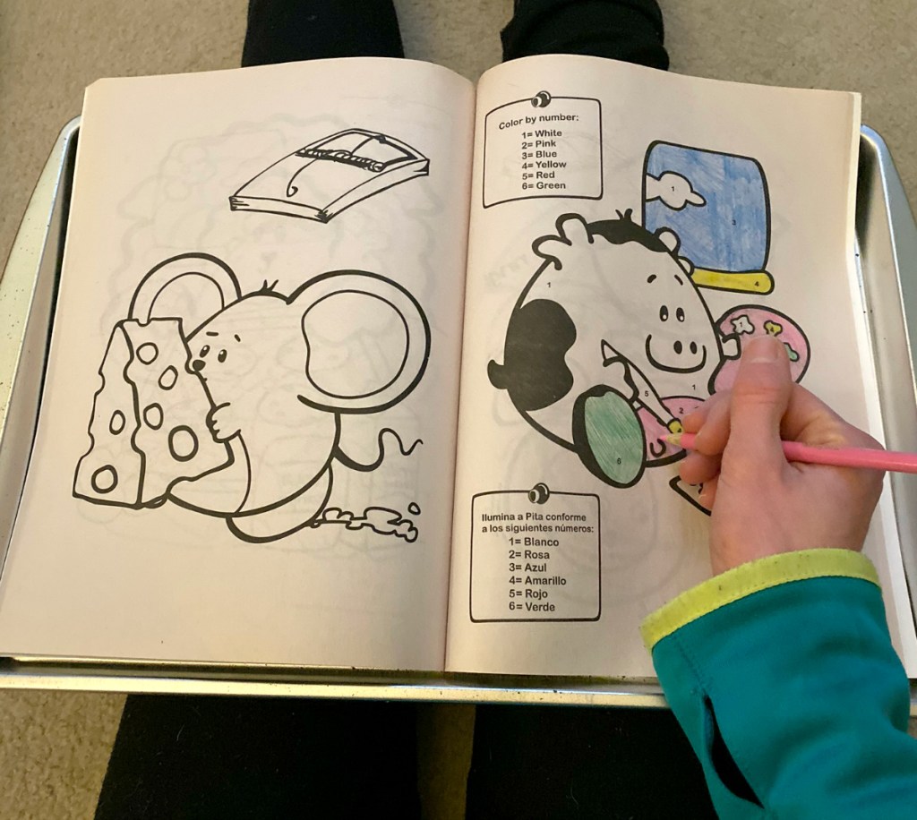 girl coloring on coloring book