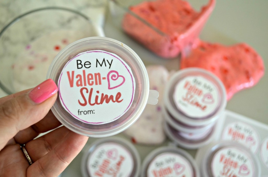 holding a small container of valentine's day slime