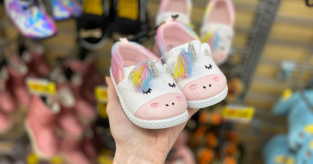 woman hand holding wonder nation baby unicorn slippers