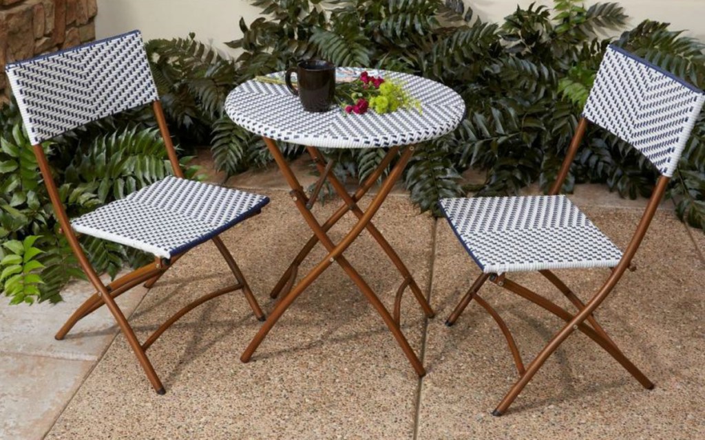 hampton bay patio table in front of greenery