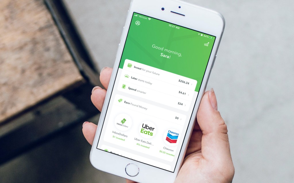 hand holding phone with acorns app on screen