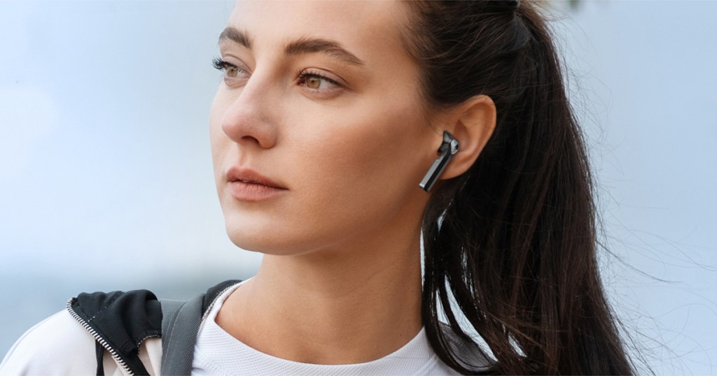 woman with black wireless bluetooth earbud in her ear