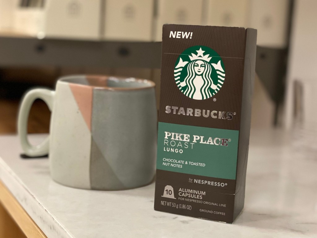 A box of Starbucks Pike Place Nespresso Pods sitting next to a mug on a counter
