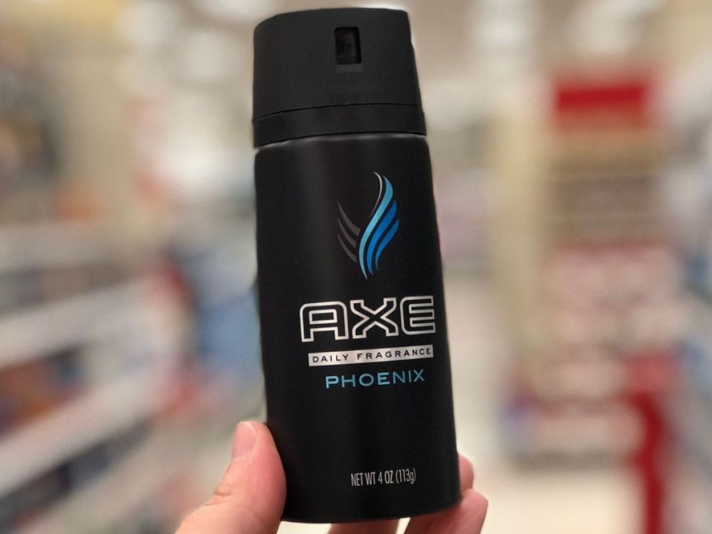Axe Body Spray held up in man's hand