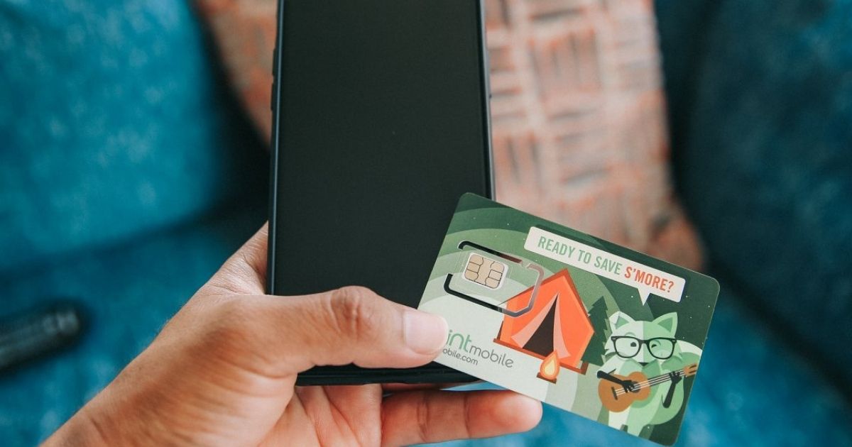hand holding Mint Mobile Card and phone