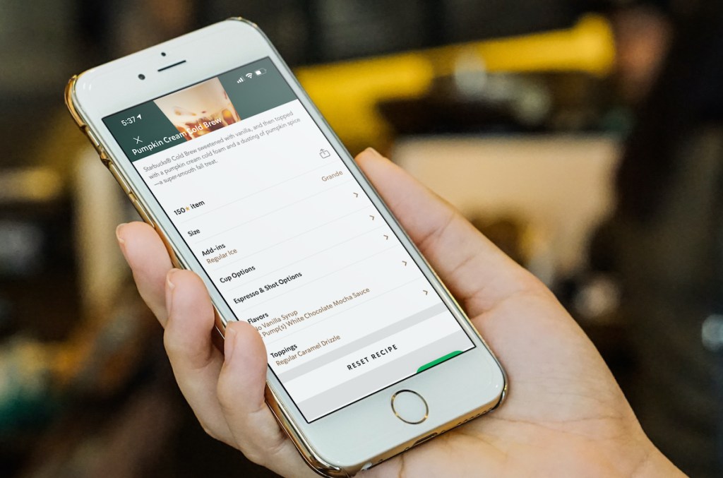 hand holding phone with candy corn cold brew order on screen