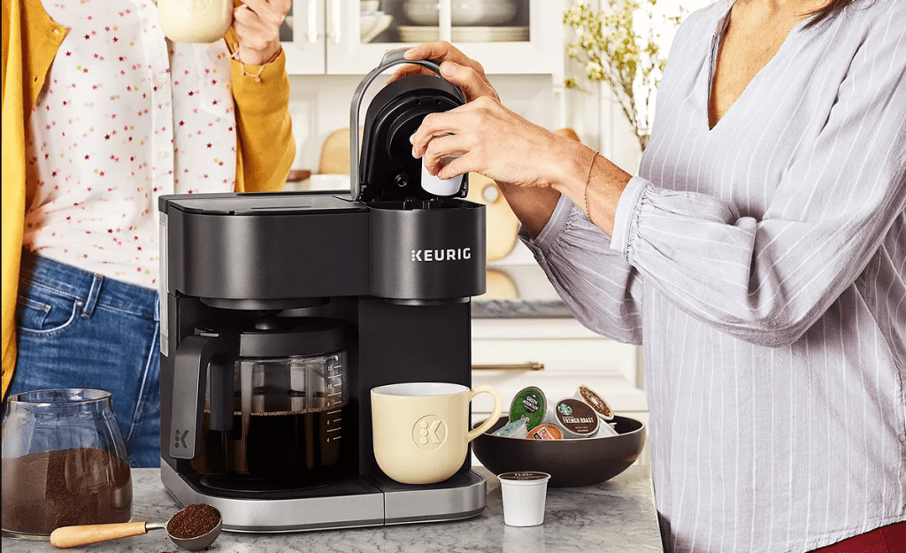 person putting a coffee pod in a coffee maker