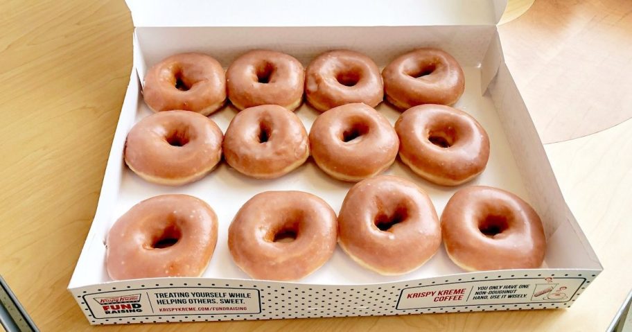 krispy kreme glazen dozen donuts in box on wood table