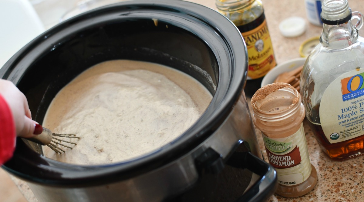 whisking together ingredients in slow cooker