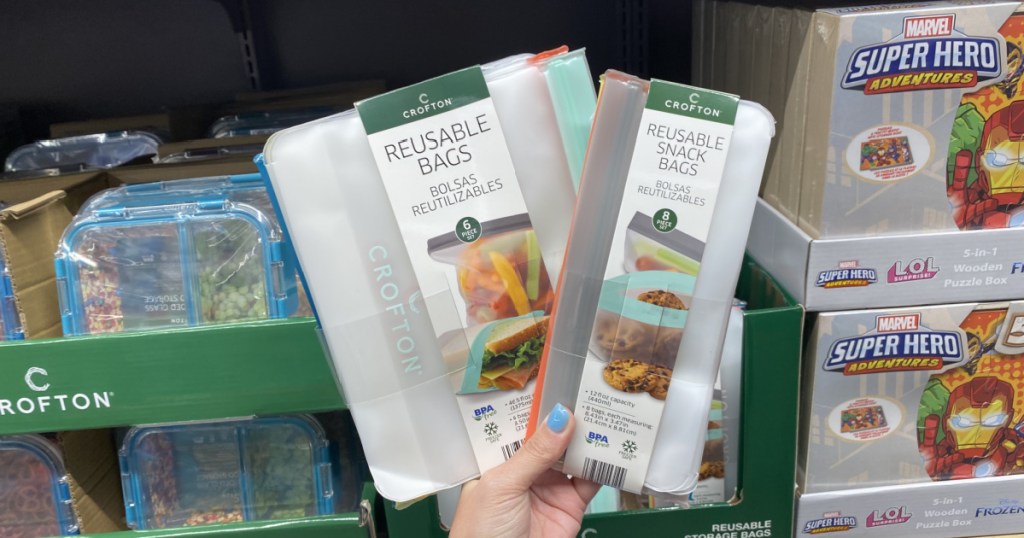 hand holding up two crofton reusable bags