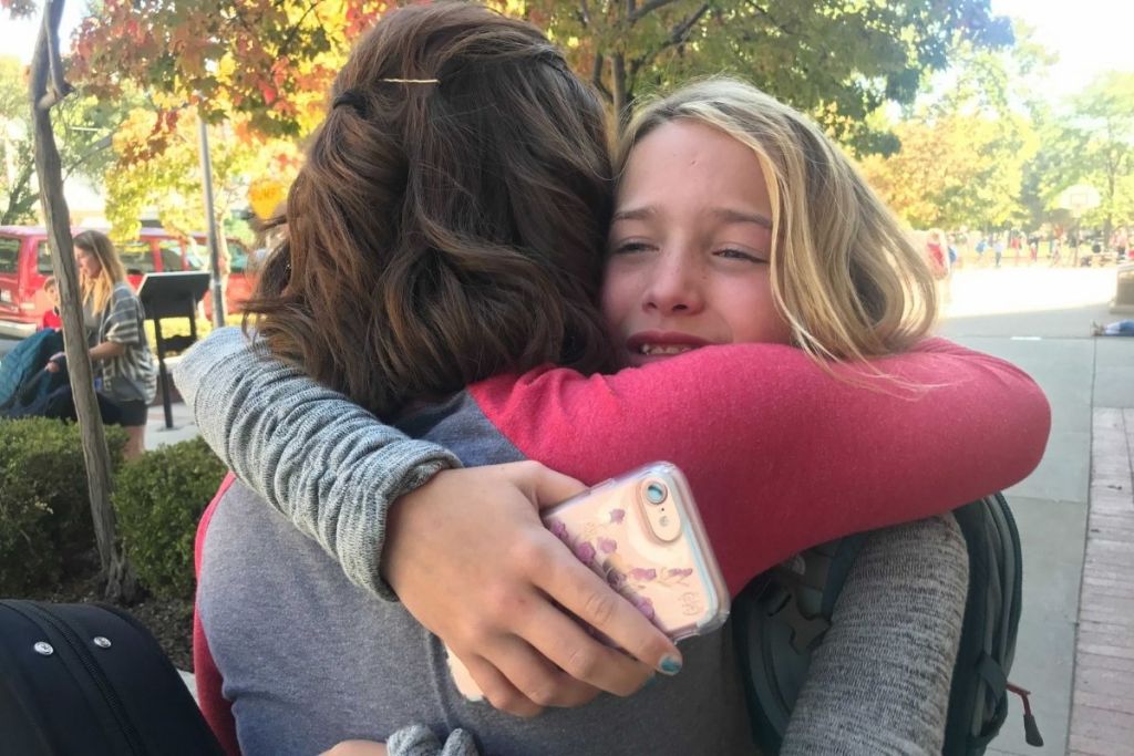 A woman hugging a child