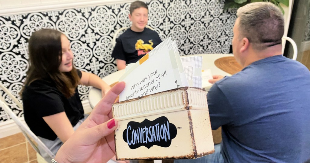 conversation cards in front of a family at the table