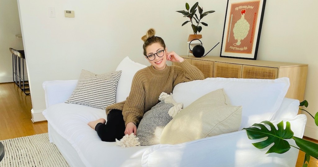 woman sitting on white couch in living room
