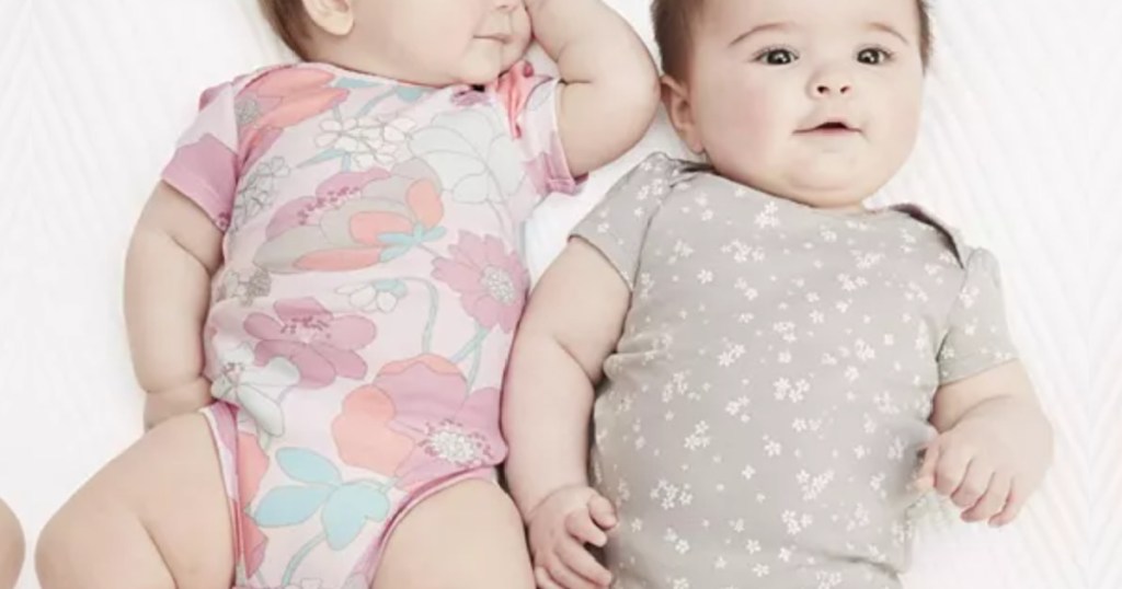 two baby girls laying next to each other