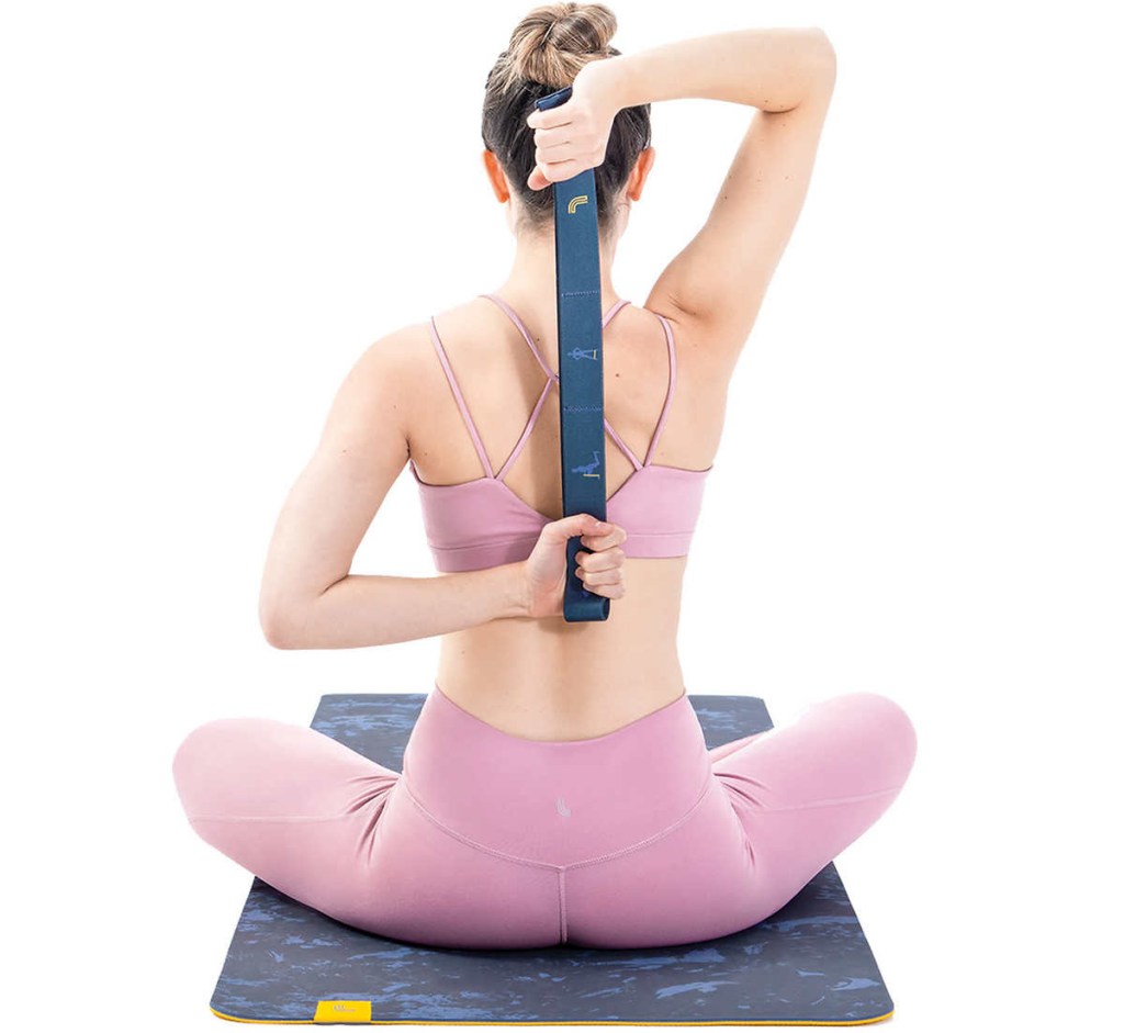 Woman using a resistance band on a yoga mat