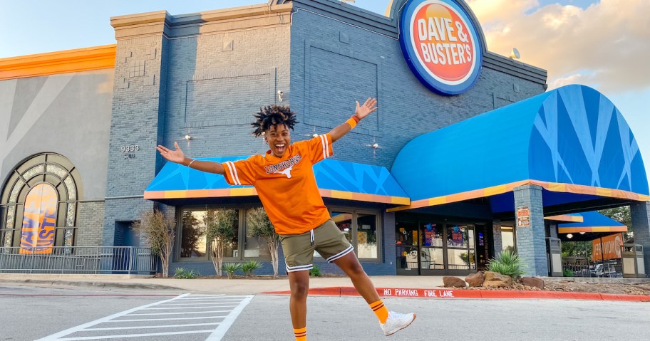 woman standing outside of dave and busters sports bar