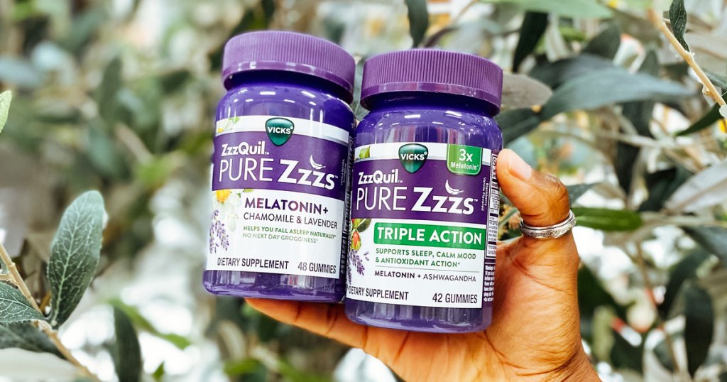 hand holding two bottles of zzzquil suppliments